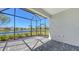 Enclosed, screened patio with paved floor offering picturesque views of the community lake at 11717 Great Brook Ln, Parrish, FL 34219