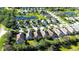 Aerial view of this suburban home shows the community pond and neighboring houses at 11836 Crawford Parrish Ln, Parrish, FL 34219