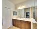 Bathroom featuring double sinks, cabinets, lighting and large mirror, creating a functional space at 11836 Crawford Parrish Ln, Parrish, FL 34219