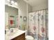 Bathroom with decorative shower curtain, neutral paint, and decorative starfish and seashell elements at 11836 Crawford Parrish Ln, Parrish, FL 34219