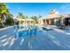 Inviting community pool area with lounge chairs, covered gazebos, and clear blue water at 11836 Crawford Parrish Ln, Parrish, FL 34219