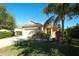 Charming one-story home with well-maintained landscaping, a two-car garage and a beautiful palm tree at 11836 Crawford Parrish Ln, Parrish, FL 34219
