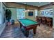 Game room featuring a pool table, bar, and stylish decor, perfect for entertaining guests at 11836 Crawford Parrish Ln, Parrish, FL 34219