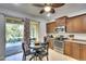 Cozy kitchen with wood cabinetry, stainless steel appliances, and adjacent screened lanai at 11836 Crawford Parrish Ln, Parrish, FL 34219
