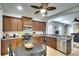 Well-appointed kitchen featuring dark wood cabinets, stainless appliances and eat in space at 11836 Crawford Parrish Ln, Parrish, FL 34219