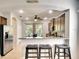 Modern kitchen featuring stainless steel appliances, dark cabinets, and breakfast bar with stools at 11836 Crawford Parrish Ln, Parrish, FL 34219