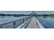 Long pier extending into a tranquil lake with a charming gazebo at the end at 11836 Crawford Parrish Ln, Parrish, FL 34219