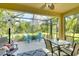 Screened lanai with patio seating and serene backyard views; ideal for relaxation at 11836 Crawford Parrish Ln, Parrish, FL 34219