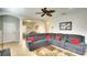 Spacious living room featuring a large gray sectional sofa and natural light at 11836 Crawford Parrish Ln, Parrish, FL 34219