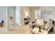 Comfortable living room with neutral paint, tile floors, plantation shutters, and bright natural light at 11836 Crawford Parrish Ln, Parrish, FL 34219