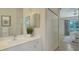 Fresh bathroom with white cabinetry, large vanity mirror, and a convenient linen closet at 12041 Thornhill Ct, Lakewood Ranch, FL 34202