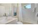 Bright bathroom with white tiled shower and tub combination, and a single sink vanity and coordinated framed art at 12041 Thornhill Ct, Lakewood Ranch, FL 34202