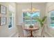 Bright dining area with lovely lighting and large windows overlooking an outdoor view at 12041 Thornhill Ct, Lakewood Ranch, FL 34202