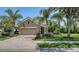 Charming single-Gathering home with a well-manicured lawn, mature landscaping, and a paved driveway at 12041 Thornhill Ct, Lakewood Ranch, FL 34202