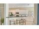 Kitchen with breakfast bar, pendant lighting, stainless appliances, and ample cabinet storage at 12041 Thornhill Ct, Lakewood Ranch, FL 34202