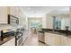 Bright kitchen features granite counters, stainless appliances, and a cozy breakfast nook with views at 12041 Thornhill Ct, Lakewood Ranch, FL 34202
