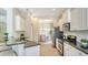 Well-lit kitchen showcases stainless steel appliances, granite countertops, and an adjacent dining area at 12041 Thornhill Ct, Lakewood Ranch, FL 34202