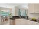 Kitchen with stainless steel appliances, granite countertops, adjacent dining area, and backyard views at 12041 Thornhill Ct, Lakewood Ranch, FL 34202