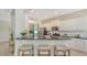 Kitchen features breakfast bar, stainless appliances, granite countertops, and view to the lanai at 12041 Thornhill Ct, Lakewood Ranch, FL 34202