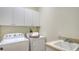 Functional laundry area with sink, cabinets, washer and dryer at 12041 Thornhill Ct, Lakewood Ranch, FL 34202
