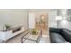 Bright living room with neutral decor, modern furniture, and open doorway to a stylish entryway at 12041 Thornhill Ct, Lakewood Ranch, FL 34202