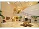 The grand lobby with elegant staircase features high ceilings, tiled floors, and refined decor at 12041 Thornhill Ct, Lakewood Ranch, FL 34202