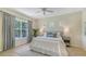Serene main bedroom featuring a plush bed, soft lighting, and a large window with garden views at 12041 Thornhill Ct, Lakewood Ranch, FL 34202