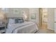 Inviting bedroom with three windows, calming decor and an ensuite bathroom entrance at 12041 Thornhill Ct, Lakewood Ranch, FL 34202