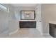 Elegant bathroom with marble tile, walk-in shower, and dark wood vanity, perfect for relaxation and style at 15024 Castle Park Ter, Lakewood Ranch, FL 34202