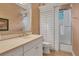 Well-appointed bathroom with white vanity, shuttered window, and a separate shower/tub area for convenience and style at 15024 Castle Park Ter, Lakewood Ranch, FL 34202