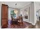 Elegant dining room with a chandelier, large window, and decorative rug at 15024 Castle Park Ter, Lakewood Ranch, FL 34202