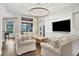 Bright living room with hardwood floors, a decorative chandelier and a wall of built-in storage at 15024 Castle Park Ter, Lakewood Ranch, FL 34202