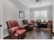 Comfortable home office featuring hardwood floors, plantation shutters, and two plush leather recliner chairs at 15024 Castle Park Ter, Lakewood Ranch, FL 34202