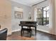 Cozy sitting area with hardwood floors and a black baby grand piano at 15024 Castle Park Ter, Lakewood Ranch, FL 34202