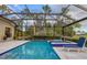 Enclosed swimming pool area with inground jacuzzi, lounge chairs, and verdant landscaping at 15024 Castle Park Ter, Lakewood Ranch, FL 34202