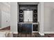 Custom wet bar with wine storage, sink, and mini fridge at 15024 Castle Park Ter, Lakewood Ranch, FL 34202