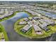 Stunning aerial view of a lakeside community with well-manicured lawns and houses surrounding a beautiful lake at 15104 Blue Bay Ter, Lakewood Ranch, FL 34211