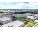 Expansive aerial view of a residential community with a central lake, showcasing numerous homes at 15104 Blue Bay Ter, Lakewood Ranch, FL 34211