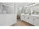 The bathroom features a spacious shower, white vanity with double sinks, and modern lighting fixtures at 15104 Blue Bay Ter, Lakewood Ranch, FL 34211