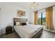 Bedroom with a comfortable bed, natural light and stylish decor at 15104 Blue Bay Ter, Lakewood Ranch, FL 34211