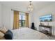 Bedroom featuring a modern light fixture, large window and neutral colors at 15104 Blue Bay Ter, Lakewood Ranch, FL 34211