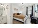 Well-lit bedroom with modern decor, a comfortable bed, and dark curtains at 15104 Blue Bay Ter, Lakewood Ranch, FL 34211