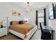 Comfortable bedroom with a queen bed, work desk, and decorative lighting at 15104 Blue Bay Ter, Lakewood Ranch, FL 34211