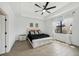 Bright bedroom featuring a ceiling fan, tray ceiling, and a comfortable bed with stylish pillows at 15104 Blue Bay Ter, Lakewood Ranch, FL 34211