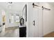 Bright foyer with a sliding barn door and views of the front entrance at 15104 Blue Bay Ter, Lakewood Ranch, FL 34211