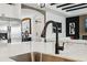 Modern kitchen with stainless steel appliances, white countertops and dark fixtures at 15104 Blue Bay Ter, Lakewood Ranch, FL 34211