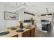 Bright kitchen with white cabinets, black backsplash, stainless steel appliances and large island at 15104 Blue Bay Ter, Lakewood Ranch, FL 34211