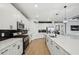 Bright kitchen features white cabinetry, stainless steel appliances, and an open floor plan at 15104 Blue Bay Ter, Lakewood Ranch, FL 34211