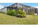 Lush landscaping enhances this yard with a screened-in patio, blending indoor and outdoor living at 15104 Blue Bay Ter, Lakewood Ranch, FL 34211