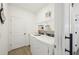 Functional laundry room featuring a washer, dryer, and shelving for storage at 15104 Blue Bay Ter, Lakewood Ranch, FL 34211